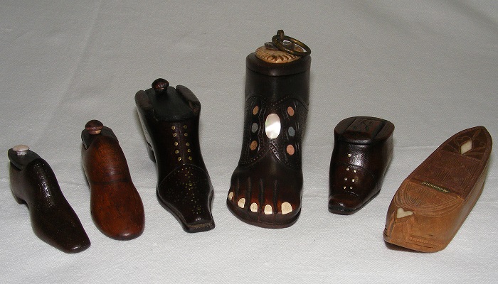 A group of six carved treen snuff boxes in the form of shoes and boots, inlaid with bone and mother of pearl.